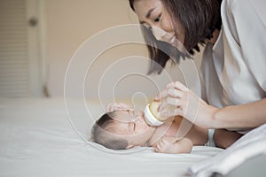 Newborn baby girl is drinking milk by  her mother