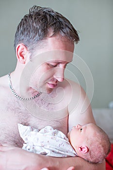 Newborn baby girl on the fathers hands