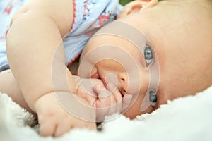 Newborn Baby Girl Laying Down Sucking Her Thumb