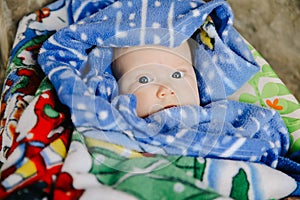 Newborn baby girl look with blue eyes on blanket