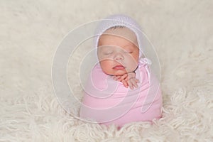 Newborn Baby Girl with Pink Bonnet and Swaddle