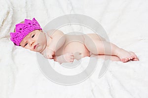 Newborn baby girl in a princess pink crown