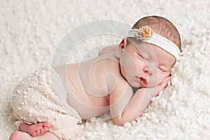 Newborn baby girl in skirt and headband