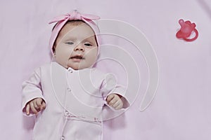 Newborn baby girl sleep on pink blan