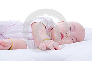 Newborn baby girl sleeping in bed