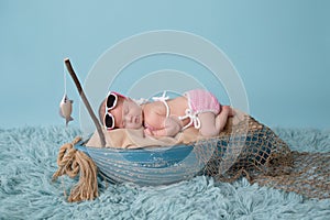 Newborn Baby Girl Sleeping in a Fishing Boat