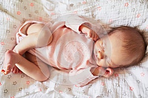 Newborn baby girl sleeping in her crib