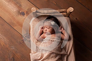 Newborn Baby Girl Sleeping in Tiny Bed