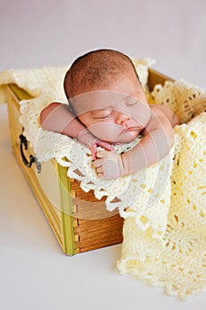 Newborn Baby Girl Sleeping in Yellow Drawer