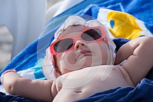 Newborn baby girl sunbathing