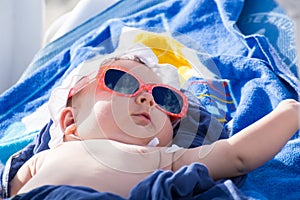 Newborn baby girl sunbathing