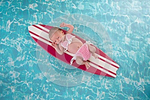 Newborn Baby Girl on Surfboard