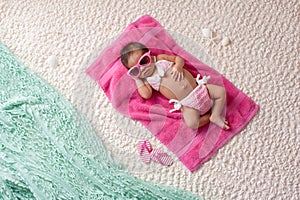 Newborn Baby Girl Wearing a Bikini and Sunglasses