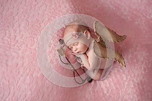 Newborn Baby Girl Wearing Cupid Wings
