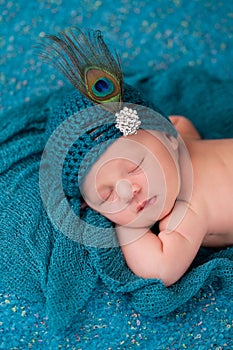 Newborn Baby Girl Wearing a Fancy Teal Hat