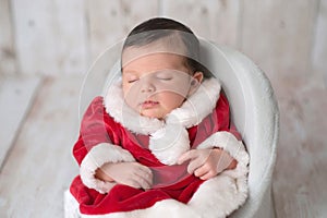 Newborn Baby Girl Wearing a Mrs. Clause Dress