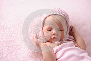 Newborn Baby Girl Wearing a Pink, Knitted Bonnet