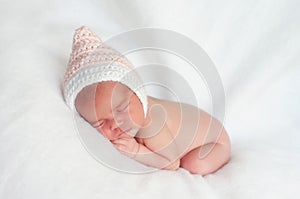 Newborn Baby Girl Wearing Pink and White Pixie Hat