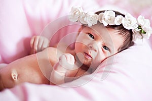 Newborn baby girl in wreath