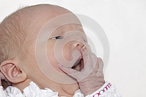 Newborn baby girl yawning