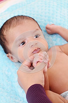 Newborn baby gripping mothers finger