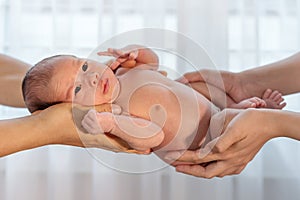 Newborn baby in hands of parent