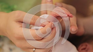 Newborn baby holding his mothers finger, selective focus