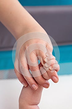 Newborn Baby Holding Mommy Hand