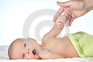 Newborn baby holding mother hand