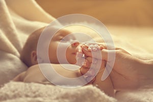 Newborn Baby Holding Mother Hand, New Born Child and Parent photo