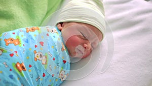 Newborn baby in hospital room. Infant sleeping in bedside bassinet. Little boy