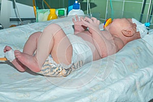Newborn baby on infant warmer system in neonatal intensive care unit