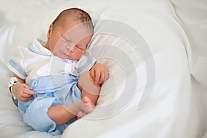 Newborn baby laying in crib in prenatal hospital