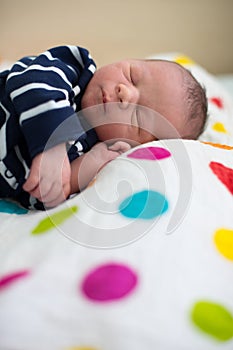 Newborn baby laying in crib in prenatal hospital