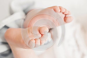 newborn baby legs. two baby feet on the background of white bed linen