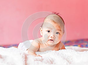 Newborn baby looking at the camera