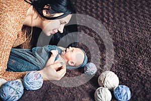 Newborn baby looks at her mother. Beautiful concept of motherhood