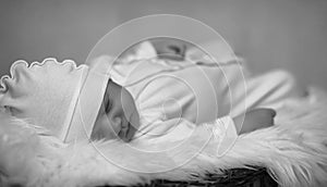 Newborn baby lying on the basket and plaid