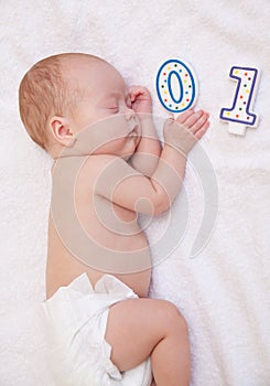 Newborn baby lying in bed