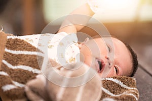 Newborn baby lying on fur fabric.