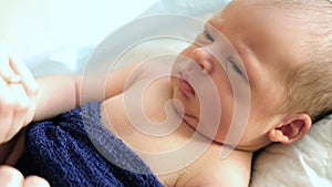 Newborn baby lying on his mother`s lap