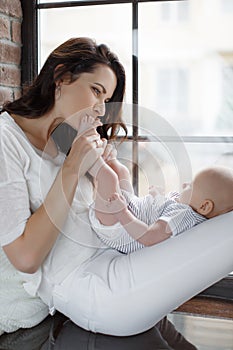 Newborn baby lying on his mother`s lap