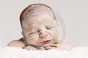 Newborn Baby Male Sleeping with Wrinkled Face