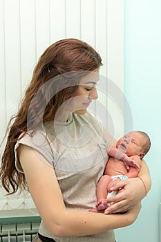 Newborn baby and mom in a maternity hospital