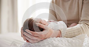 Newborn baby, mother and hands on hair with love to touch, mama connection and safety on bed. Motherhood, infant and