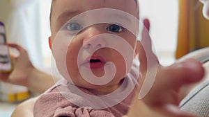 newborn baby and mother meet face to face in front of a window. The first meeting of the baby with his mother in front