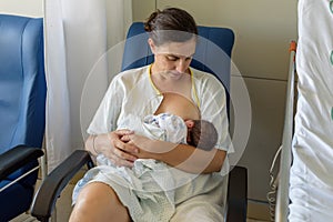 Newborn baby in mother`s arms in photo