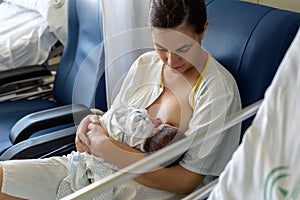 Newborn baby in mother`s arms in photo