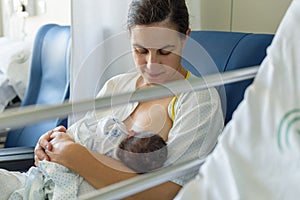 Newborn baby in mother`s arms in photo