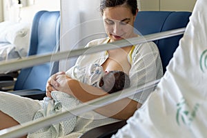 Newborn baby in mother`s arms in photo